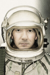 Portrait of a female astronaut in a space suit looking at camera