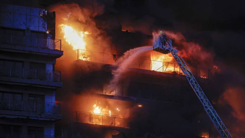 Firemen try to extinguish a fire of a 14-story residential building in Valencia, eastern Spain, 22 February 2024. At least seven people were injured during the ongoing fire, and two people trapped on a balcony were rescued by firefighters. Fot. PAP/EPA/MANUEL BRUQUE