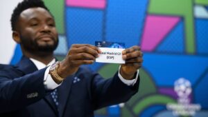 Former Nigeria soccer player John Obi Mikel shows a ticket with Real Madrid during the draw for the UEFA Champions League quarter-finals at the UEFA headquarters in Nyon, Switzerland, 15 March 2024. Fot. PAP/EPA/JEAN-CHRISTOPHE BOTT