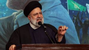 Iranian president Ebrahim Raisi speaks to the crowd in front of an image of the late Iran's Islamic Revolutionary Guard Corps (IRGC) Quds Force commander Qasem Soleimani during the fourth anniversary of his death, in Tehran, Iran, 03 January 2024. On the fourth anniversary of the assassination of Iranian General Qasem Soleimani, two explosions have killed at least 103 people and another 171 people were wounded near the mausoleum dedicated to him, according to Iranian state television. As part of a ceremony to honor General Soleimani, who was killed in a drone strike in neighboring Iraq in 2020, hundreds of people were on their way towards the grave on 03 January. Fot. PAP/EPA/ABEDIN TAHERKENAREH