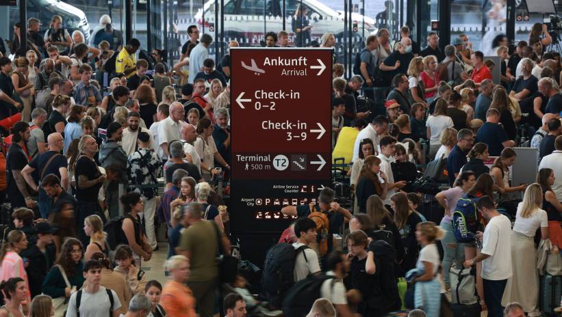 Passengers wait in front of counters at BER Airport in Schoenefeld, Germany, 19 July 2024. BER Airport stated in their 'X' social media account (former Twitter) that check-in will be delayed due to a technical fault. Companies and institutions around the world have been affected on 19 July by a cyber outage in systems running Microsoft Windows linked to a faulty CrowdStrike update. According to CrowdStrike's CEO, the issue has been identified, isolated and a fix has been deployed. Fot. PAP/EPA/CLEMENS BILAN