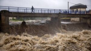 A local man walks on a bridge over the overflowing Bela river in Mikulovice, Czech Republic, 14 September 2024. The Czech Hydrometeorological Institute (CHMU) has issued a extreme precipitation warning of unusually intense rainfall which can significantly raise water levels and that will affect the Czech Republic from 12 September until the end of the week. Fot. PAP/EPA/MARTIN DIVISEK